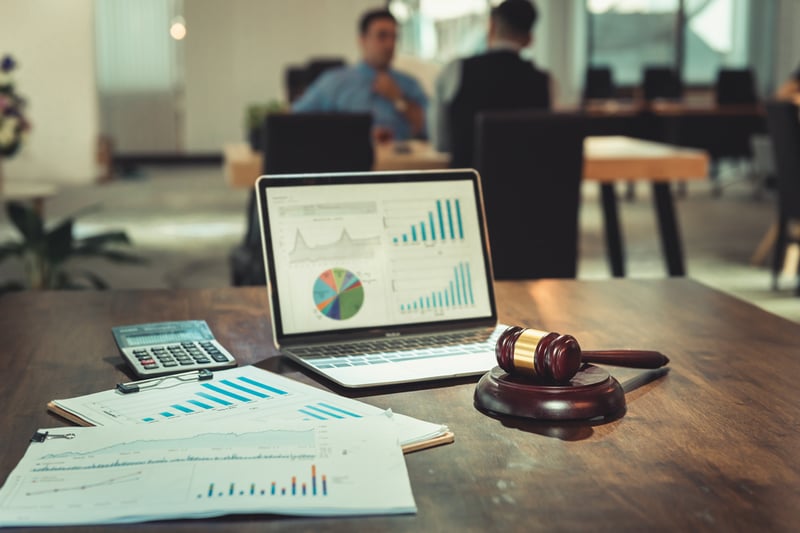 Gavel on a desk in front of laptop showing course information